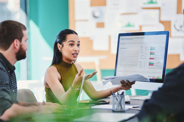 A team of business professionals discuss marketing strategies for their display ads, including targeting and retargeting.