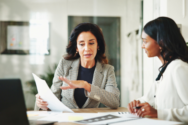 Two businesswomen discuss the plan for the marketing budget for the next year.
