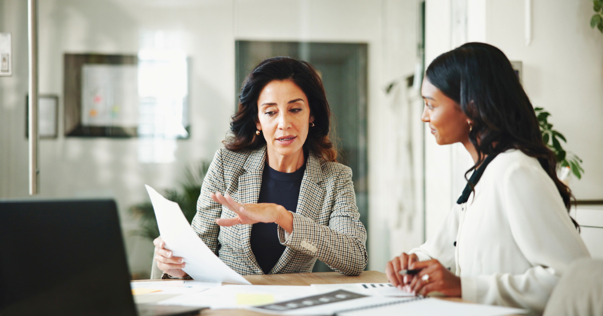 Two businesswomen discuss the plan for the marketing budget for the next year.