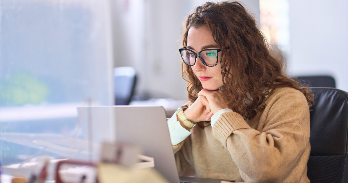 A young woman ponders an Internet search on her laptop computer