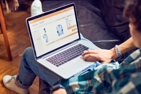 A young man shops for clothes online. If he doesn't make a purchase, he will be retargeted with an ad.