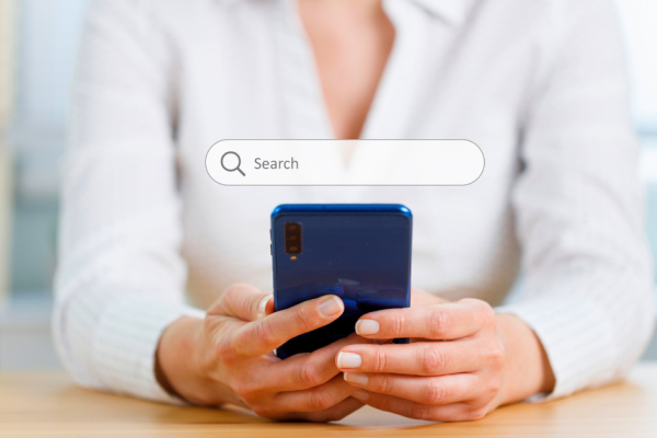A woman starts a web search on her mobile phone.