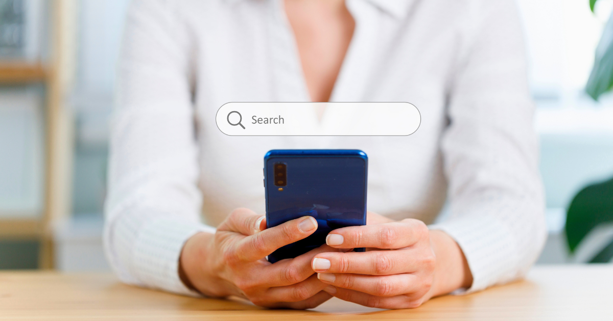A woman starts a web search on her mobile phone.
