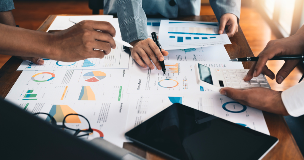 Business people review reporting on their marketing efforts to decide what's working and what's not.