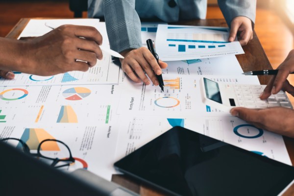 Business people review reporting on their marketing efforts to decide what's working and what's not.