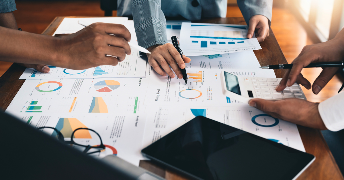 Business people review reporting on their marketing efforts to decide what's working and what's not.