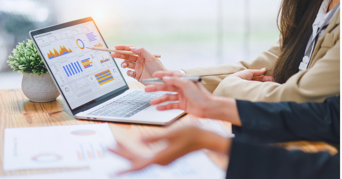 A pair of business people calculate the true roi of their marketing efforts.